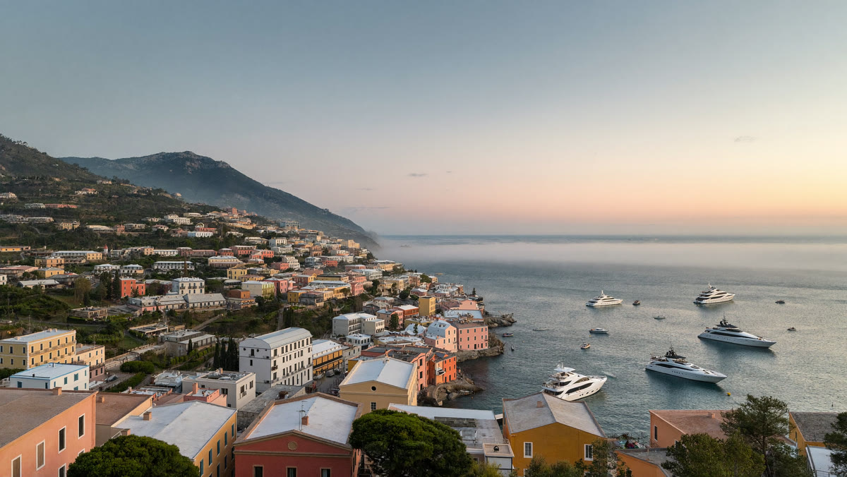 Ligurian coastal village at dawn, with yachts at anchor in the bay